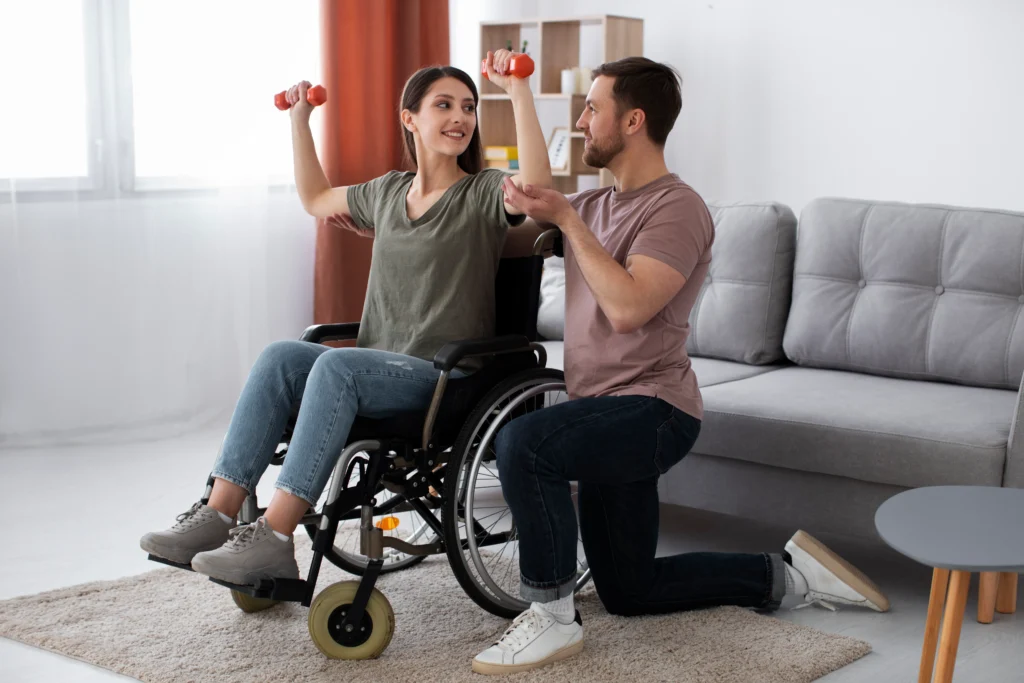 Woman in a wheelchair doing physical therapy exercises at home with assistance.